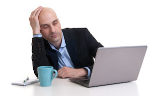 Tired businessman sleeping on a laptop - isolated over white