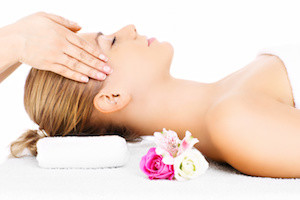 A portrait of a happy woman having a massage over white background